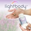 Hands holding Lightbody Total Stress Support Supplement Bottle.