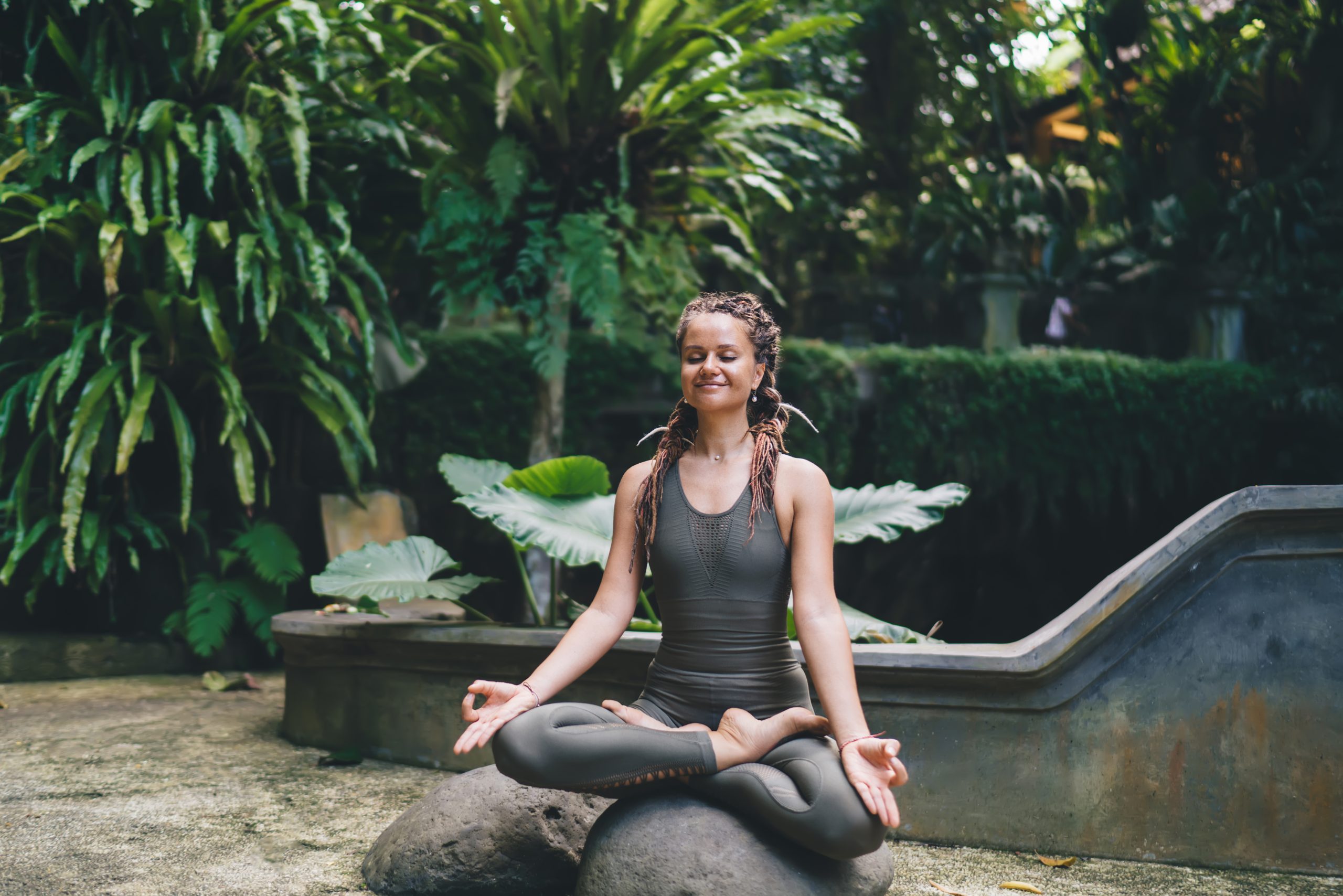 Content woman relaxing in lotus pose – a picture illustrating Lightbody Women's Mental Health blog.